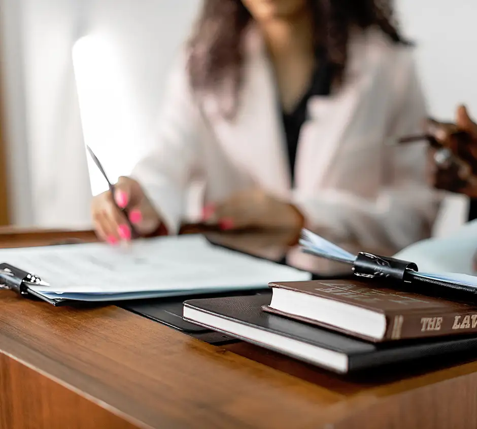 woman with contracts on desk